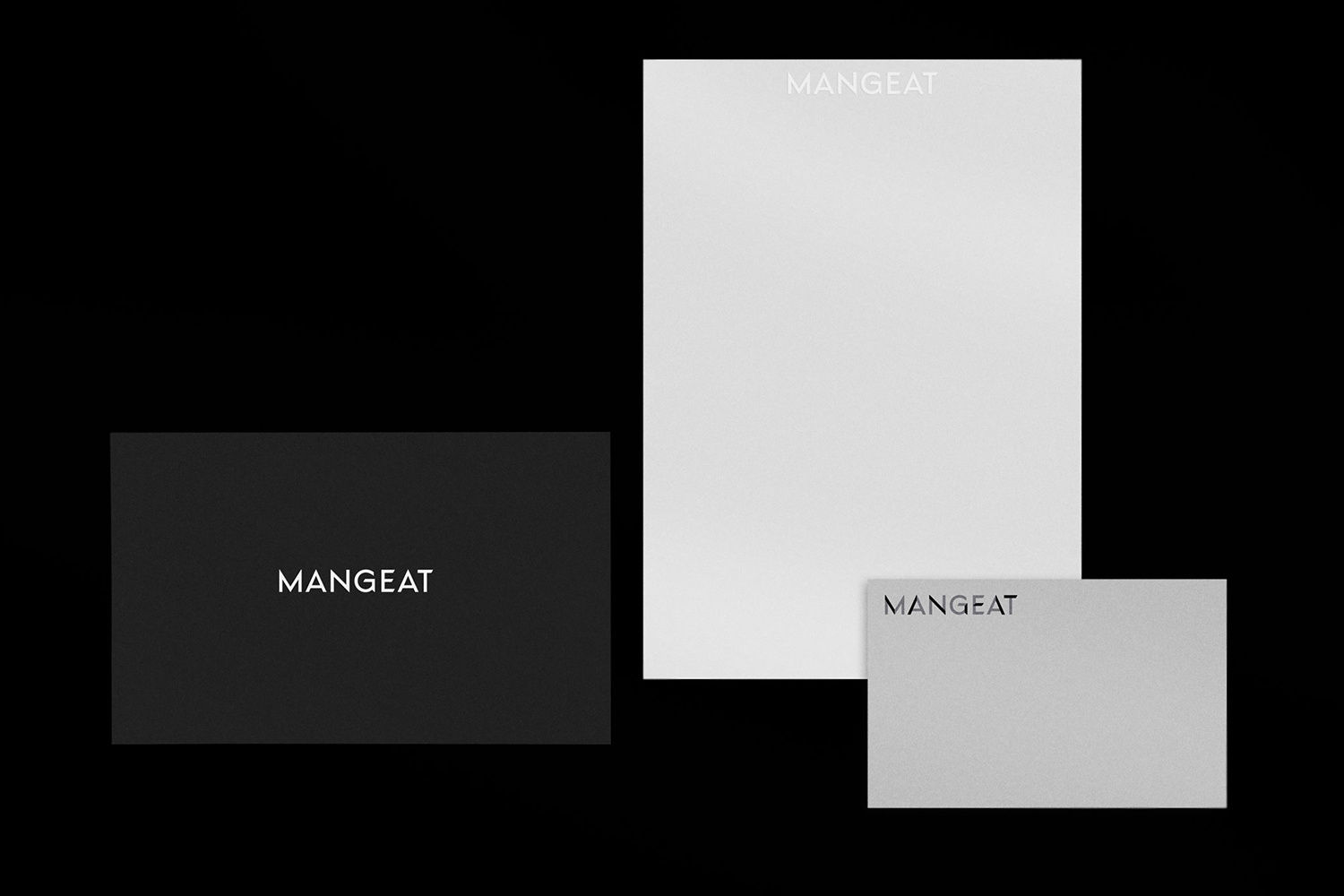 Minimalist brand identity layout featuring business cards and stationery for Mangeat against a solid black background.