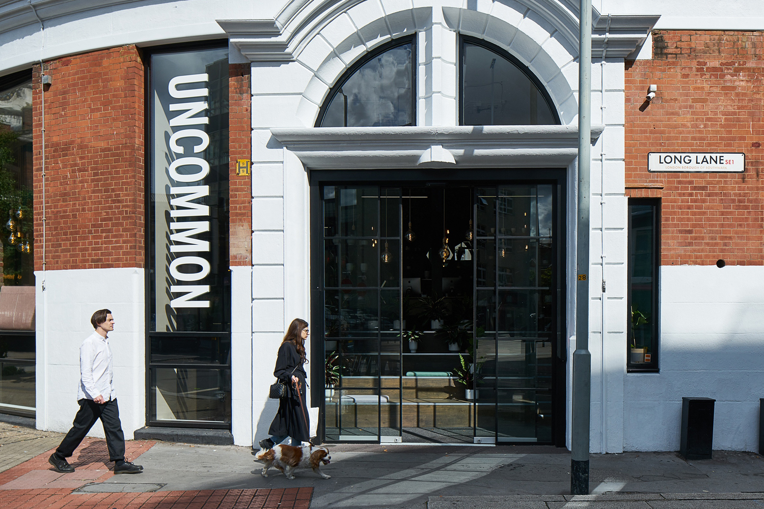 Exterior storefront of Uncommon with people walking past on the pavement on Long Lane