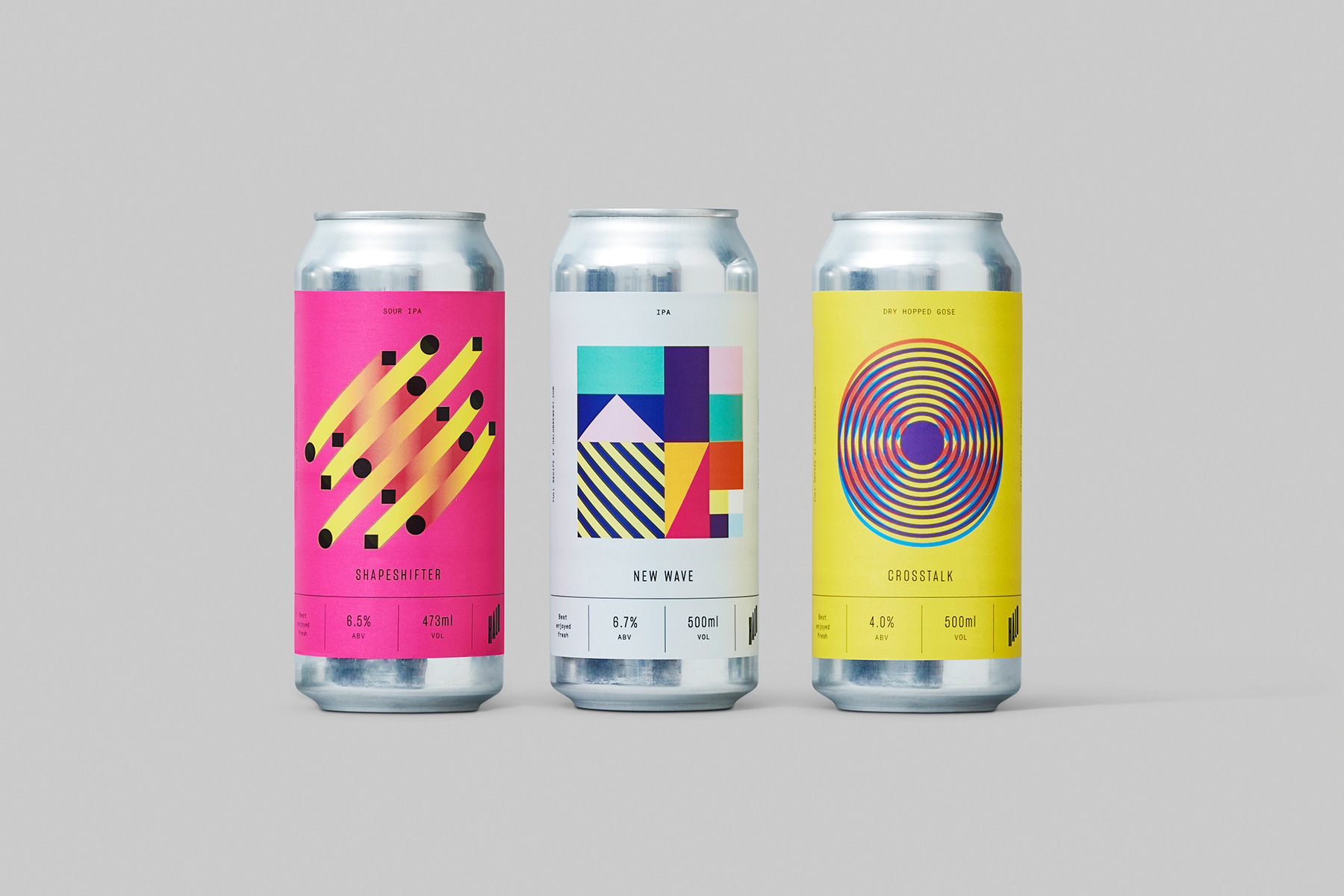 Three aluminium beer cans featuring colourful geometric label designs against a plain grey backdrop.