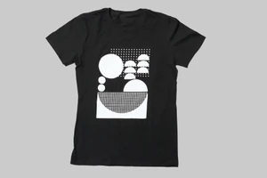 Black t-shirt featuring a white geometric graphic print centered on the chest against a grey background.
