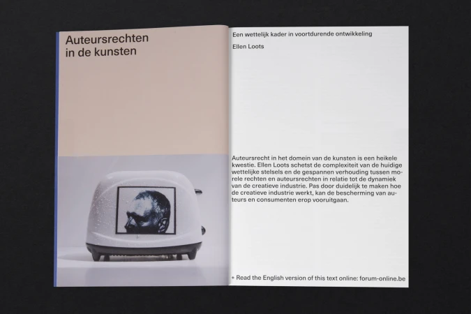 Open publication layout featuring minimalist typography and an image of a toaster with a human head on its side