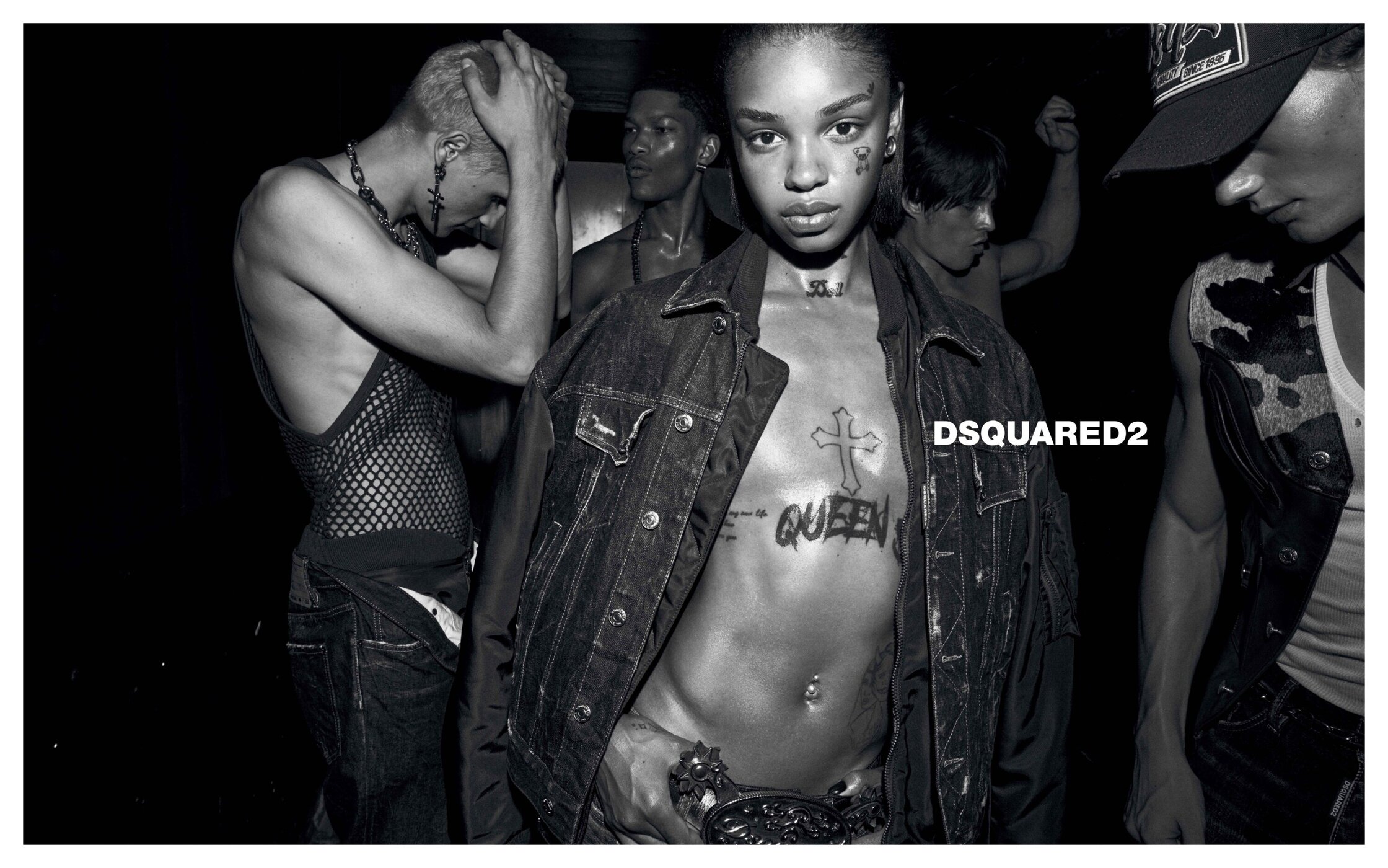 Black and white portrait of multiple models posing in a dimly lit club setting for Dsquared2 Fall 2025 campaign.