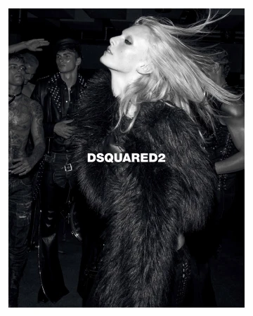 Black and white editorial fashion campaign shot featuring a model with long flowing hair wearing a dark faux fur coat.