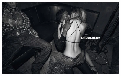 Black and white editorial campaign image for Dsquared2 featuring a couple embracing on a dark leather booth in a club setting.