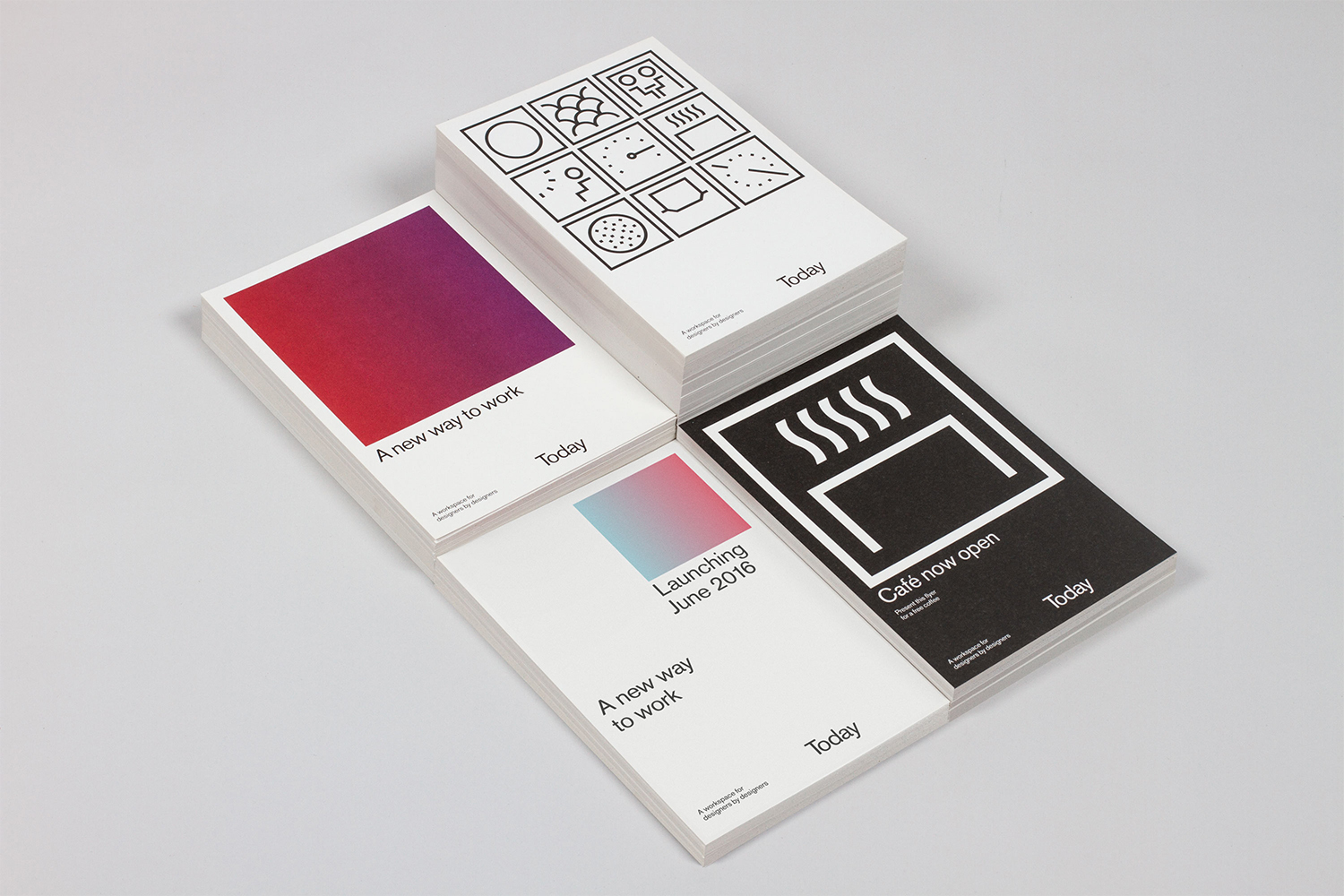 Stacks of branded Today business cards and promotional flyers with typographic layouts on light grey background