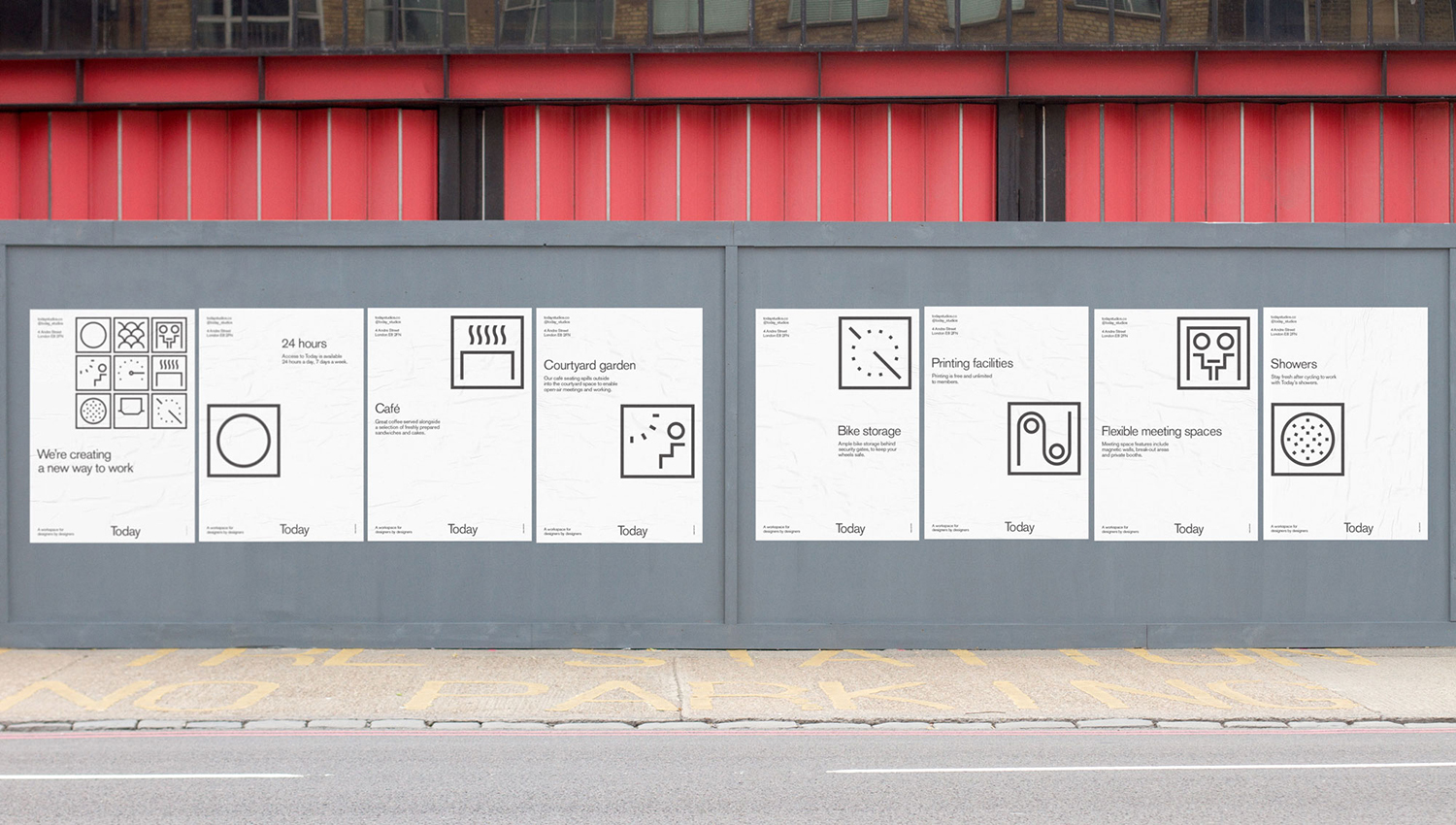 Monochrome graphic posters with minimalist icons mounted on a grey construction hoarding below red beams.