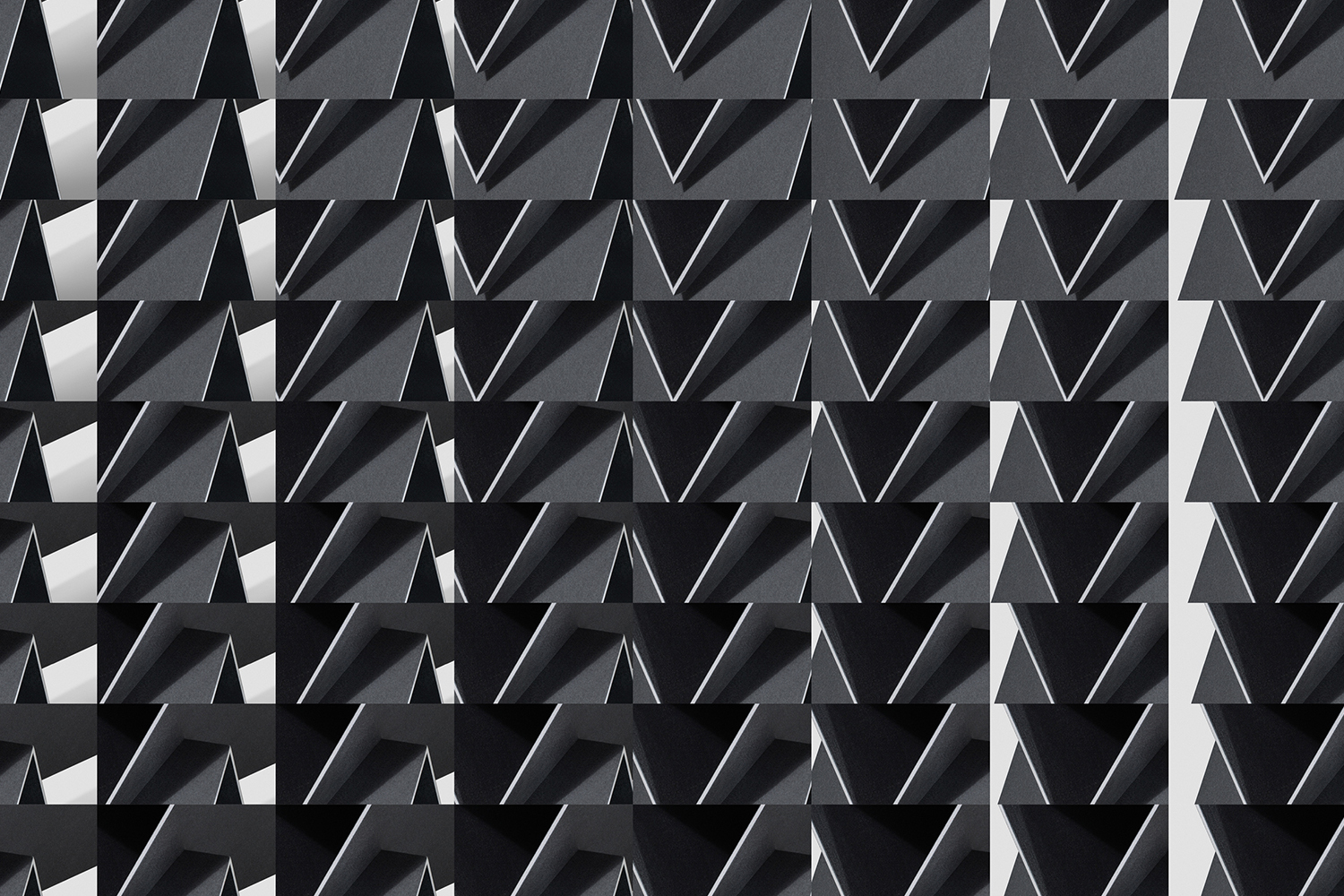 Monochrome geometric pattern featuring repeating triangular shapes and stark shadows creating a graphic architectural grid.