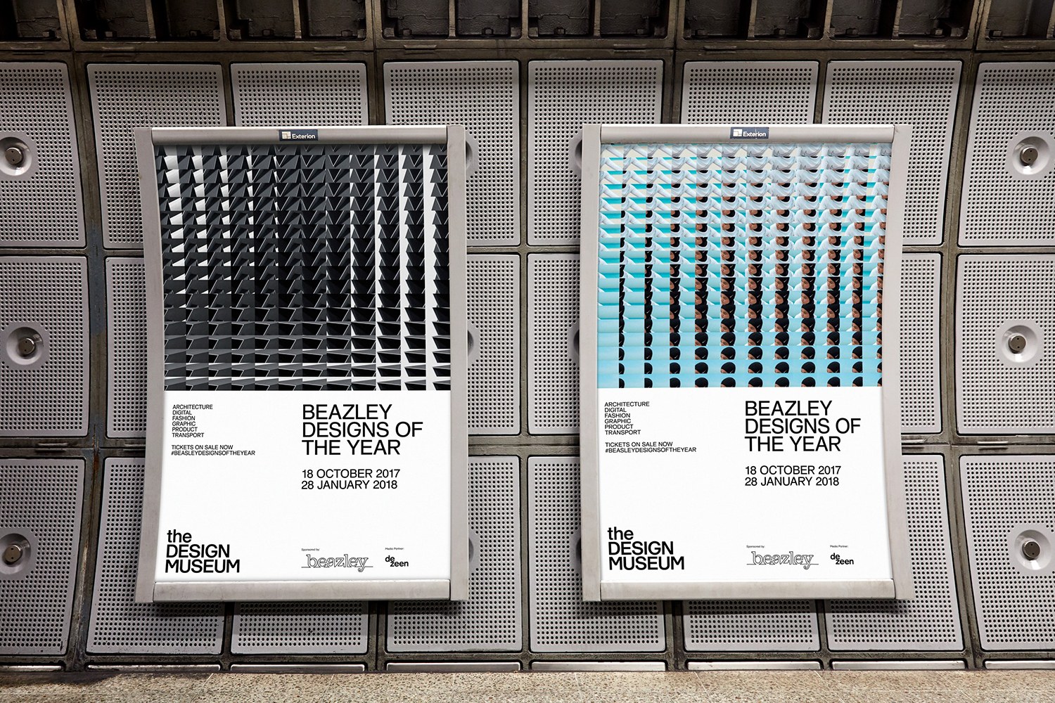 Two vertical advertising posters for Beazley Designs of the Year mounted on a perforated metal wall inside a transit station.