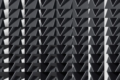 Monochrome geometric pattern featuring repeating triangular shapes and stark shadows creating a graphic architectural grid.