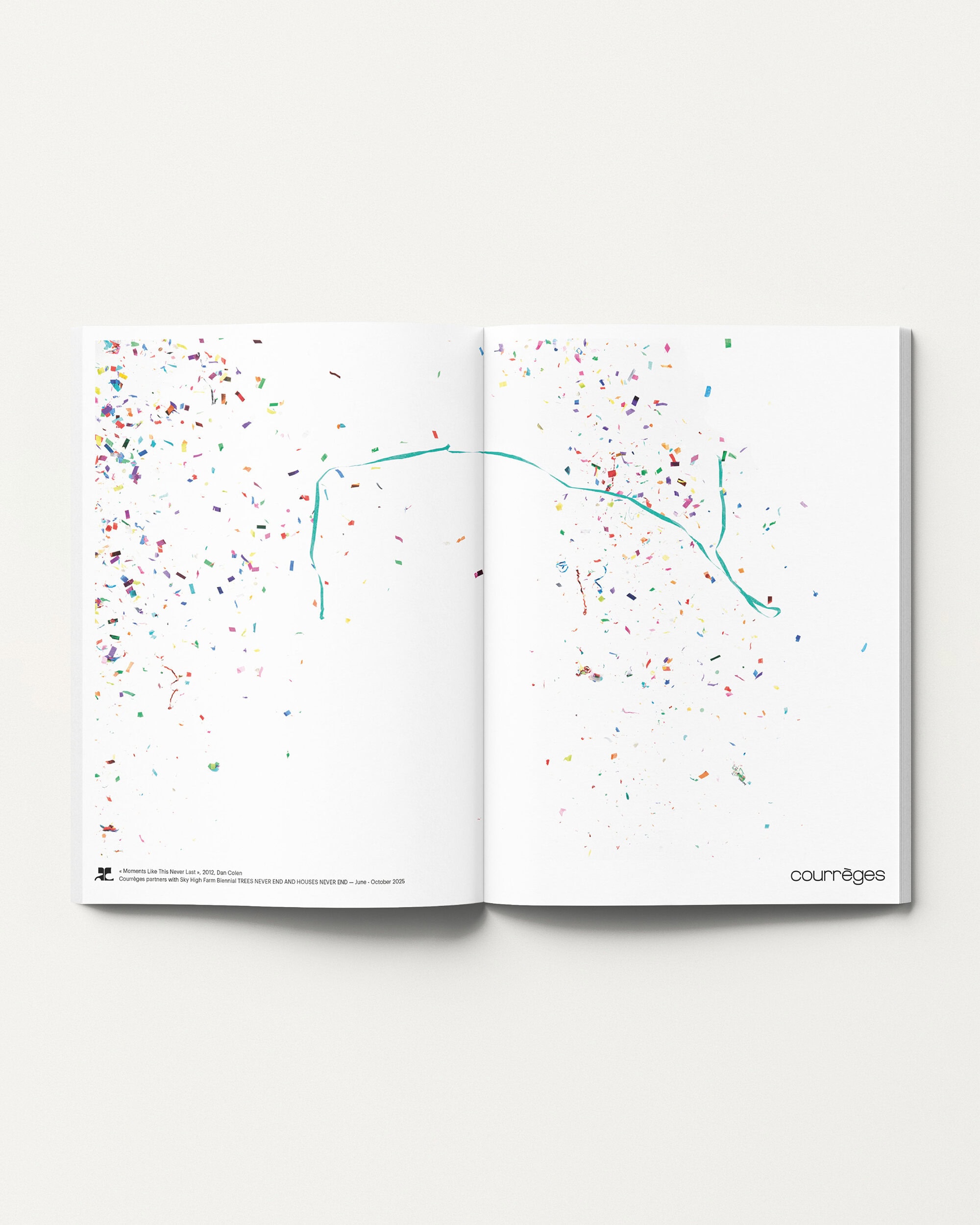 An open magazine spread featuring colorful confetti scattered across white pages with a teal line drawing against a white background.
