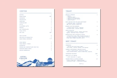Two white menu cards with blue typography and mountain illustration set against a pale pink background