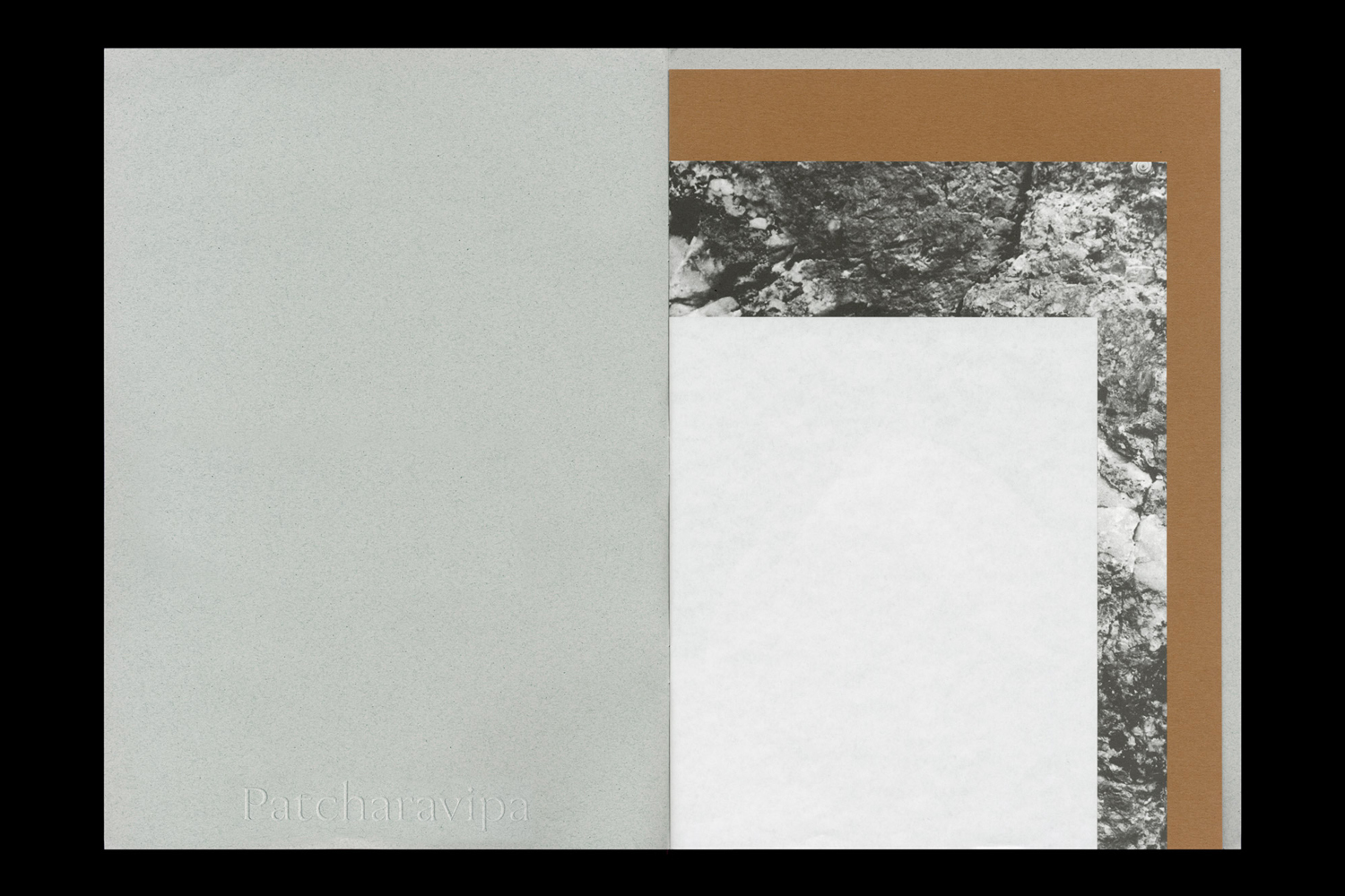 Open book layout featuring textured grey pages, a brown insert, and layered black-and-white rock imagery.