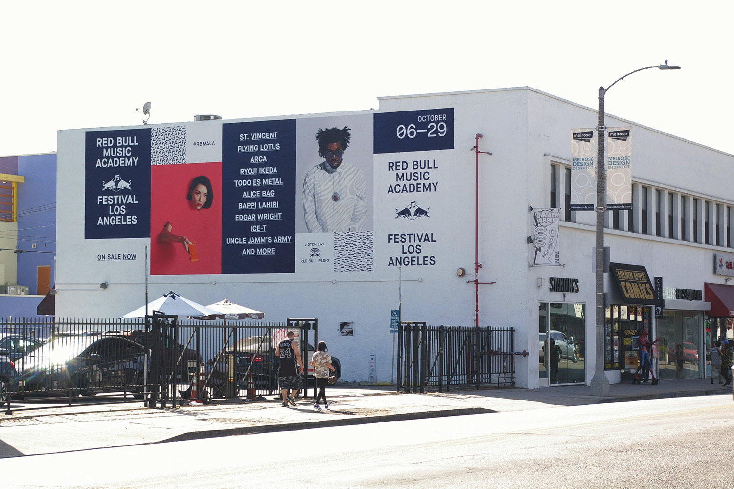 Large Red Bull Music Academy mural advertisement displayed on a white building exterior next to a street in Los Angeles.