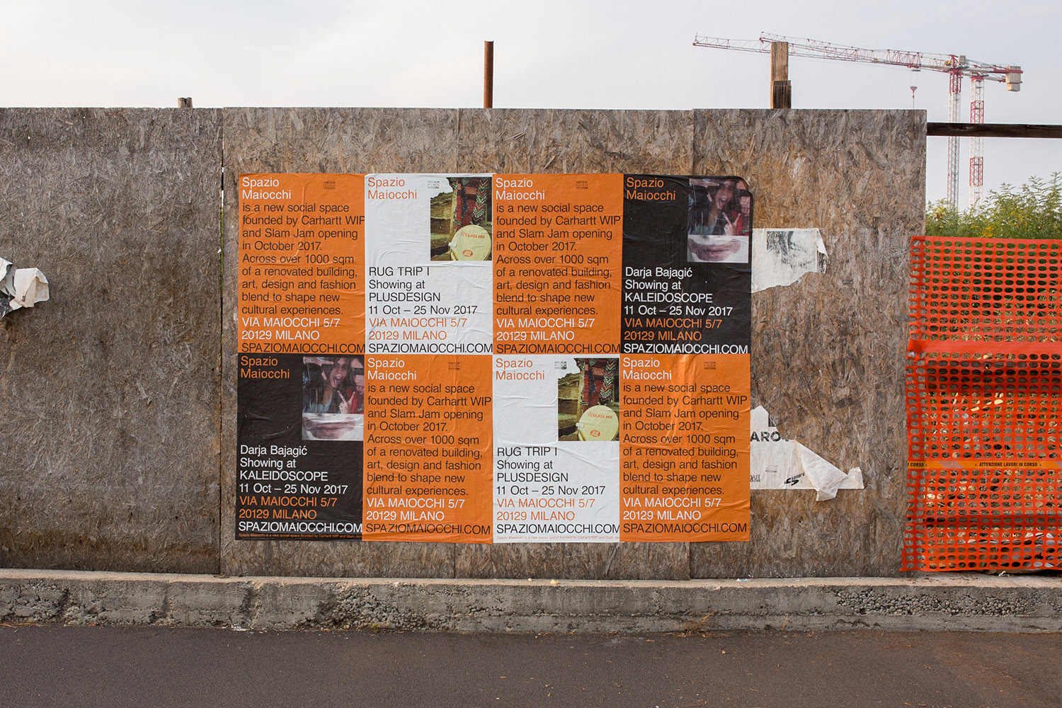 Posters pasted on a plywood construction wall promoting Spazio Maiocchi founded by Carhartt WIP and Slam Jam