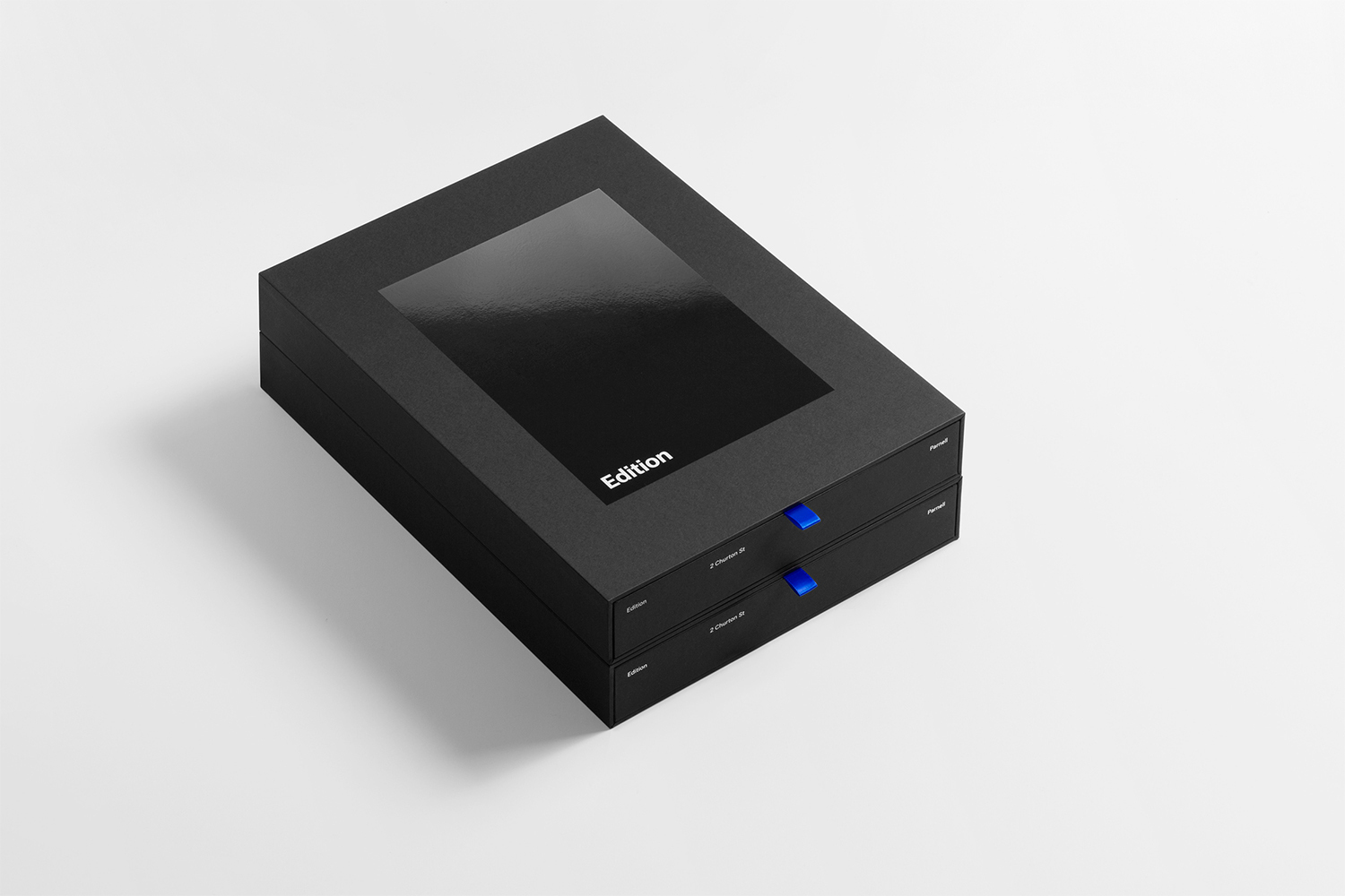 Black presentation box with a glossy inset panel and blue ribbon pull tabs on a white background