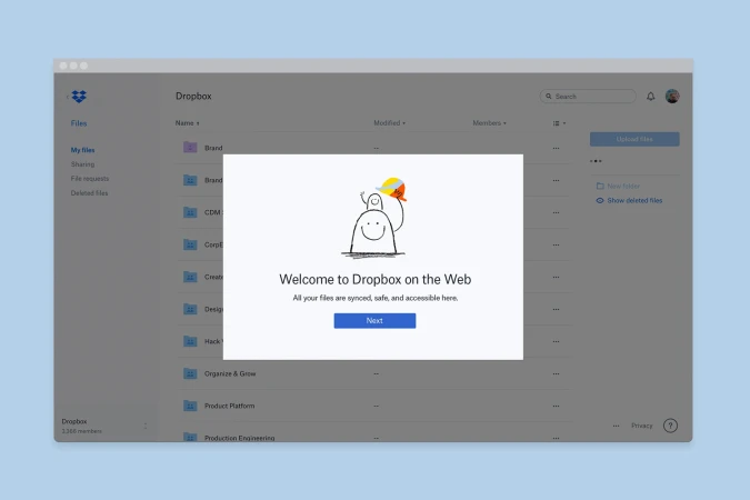Digital interface screenshot displaying a Dropbox web application welcome modal with a hand-drawn cartoon illustration.