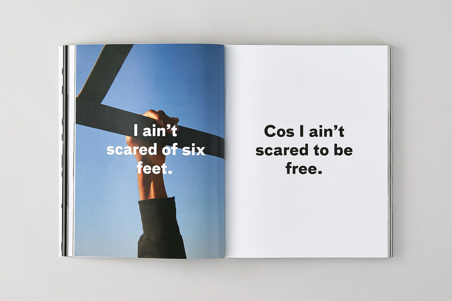 Spread of Brick Magazine showing a hand gripping a dark bar against a blue sky with bold text on both pages.
