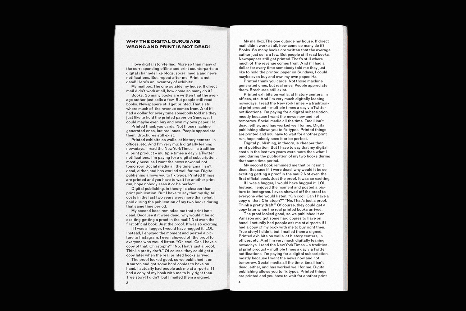 Open book showing two pages of black text columns on a plain white paper background