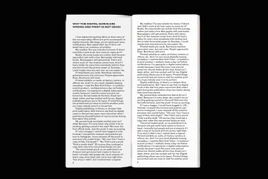 Open book showing two pages of black text columns on a plain white paper background