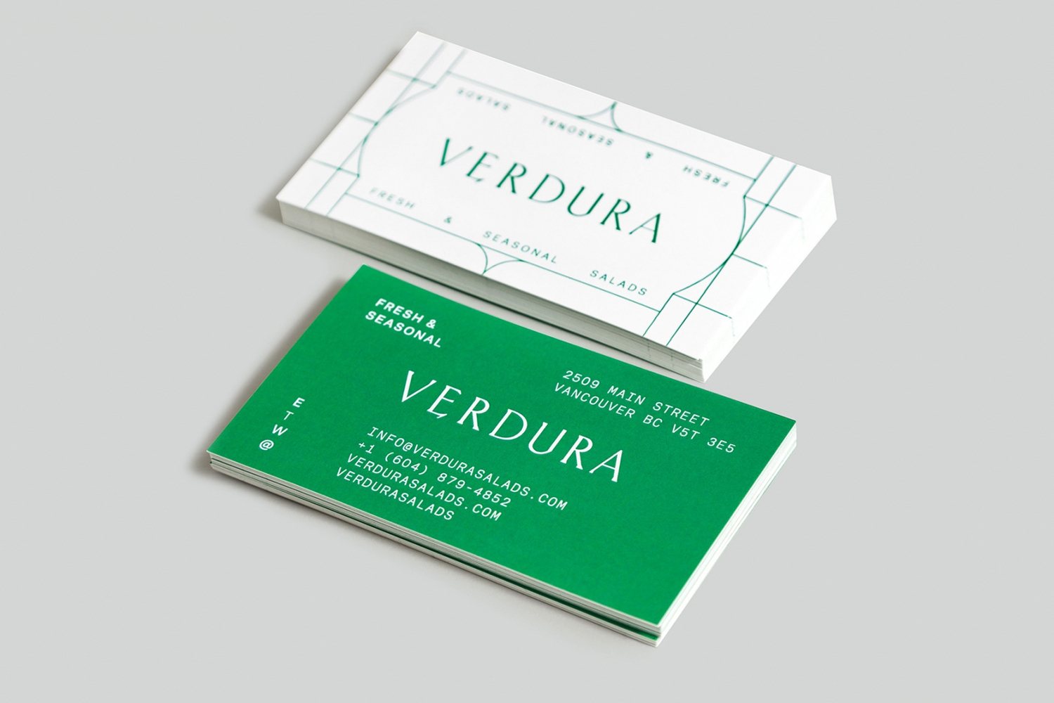 Two stacked business cards for Verdura featuring green and white typography against a neutral grey background.