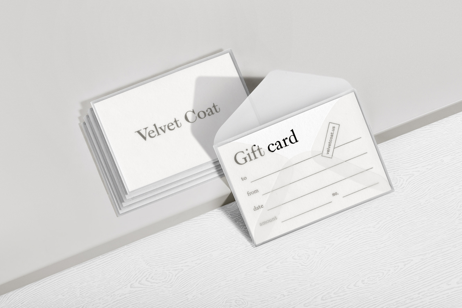 Velvet Coat gift card set in translucent envelopes on a white surface