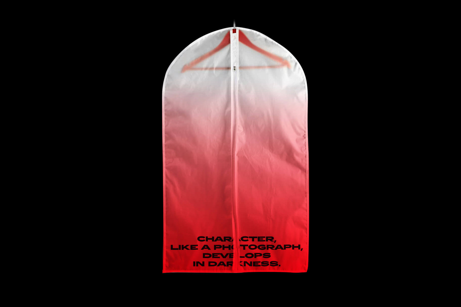 White and red gradient garment bag with a wooden hanger inside and quote text at the bottom against solid black background.