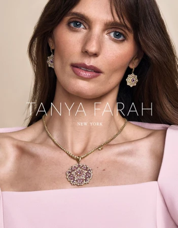 Close-up of a woman wearing a gold necklace with a flower pendant and matching earrings for Tanya Farah New York jewelry brand.
