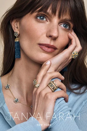 Close-up portrait of a woman wearing blue gemstone tassel earrings and ornate rings, shot by Yossi Michaeli for Tanya Farah.