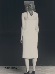 Model from behind wearing a white dress and black shoes with a square prop behind head against dark background.
