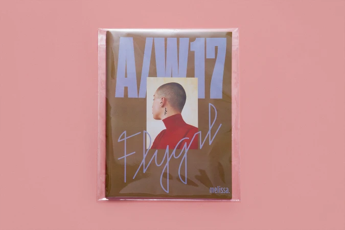Packaged publication cover with text A/W 17 Flygirl and portrait inset on pink background