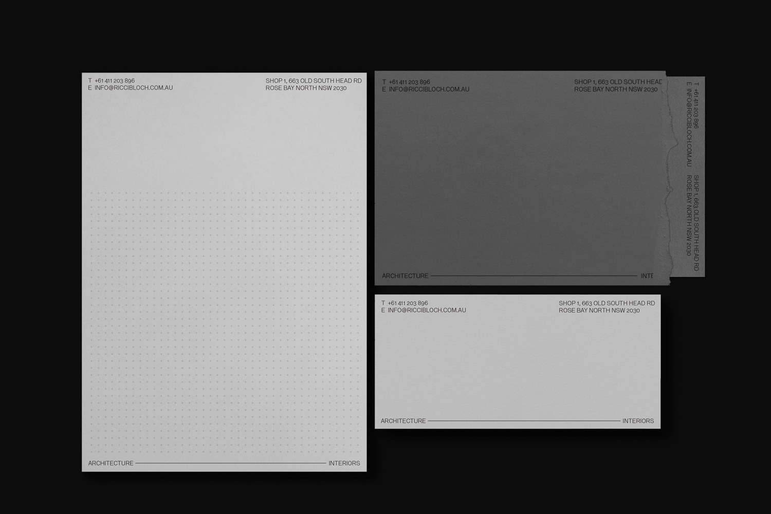 Minimalist stationery set including letterhead, envelopes, and business cards featuring clean typographic layout on neutral paper.