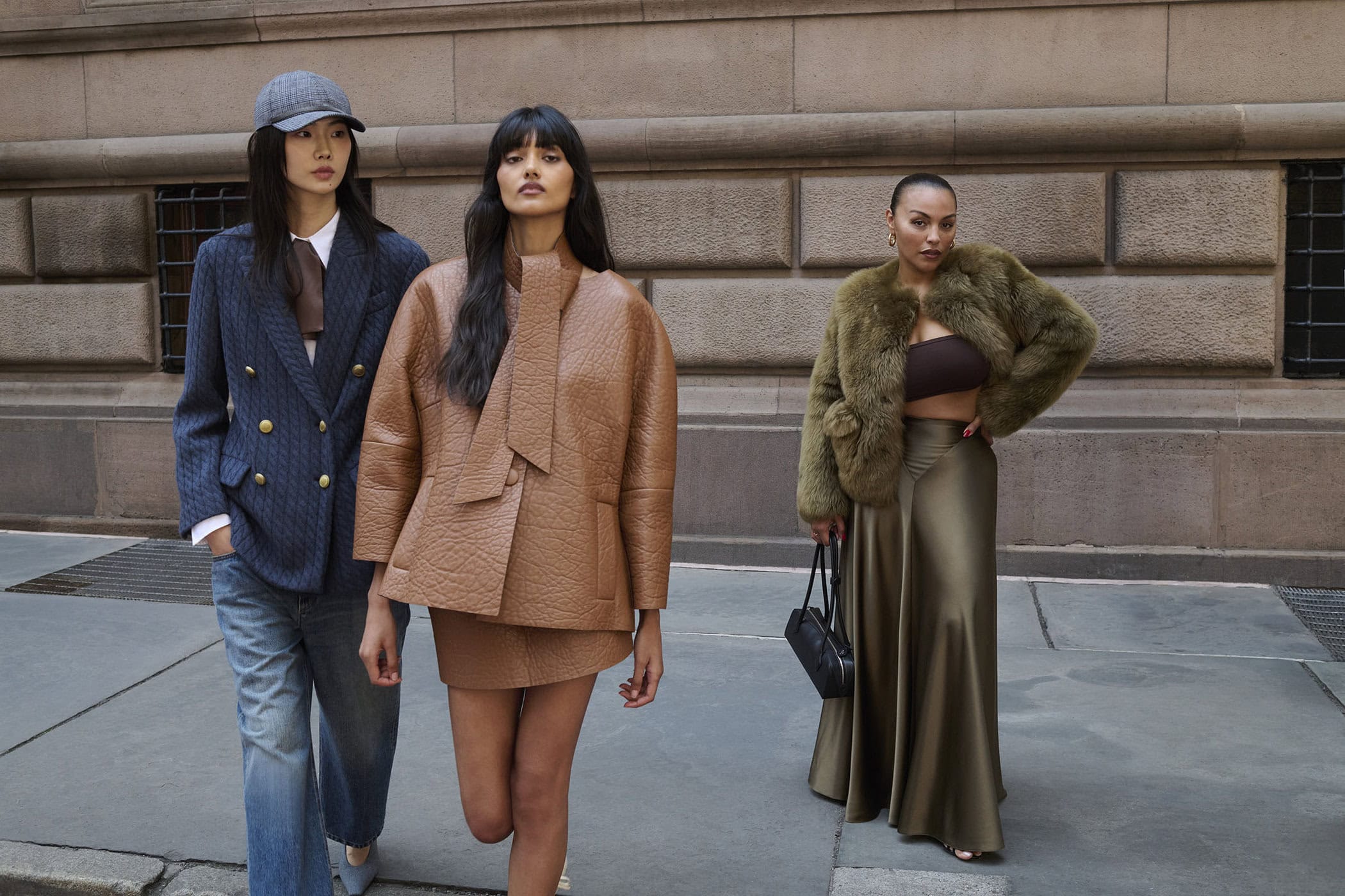Three female models posing on a city street in fall fashion attire by Saks Fifth Avenue photographed by Angelo Pennetta.
