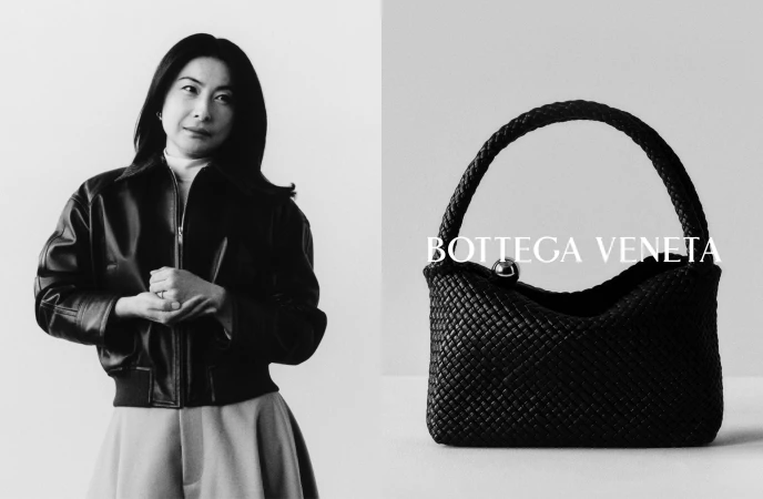 Black and white portrait of a woman standing beside a woven leather handbag with Bottega Veneta text