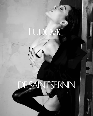 Model in black thigh-high boots leaning against a metal structure with overlaid brand text in a monochrome campaign image