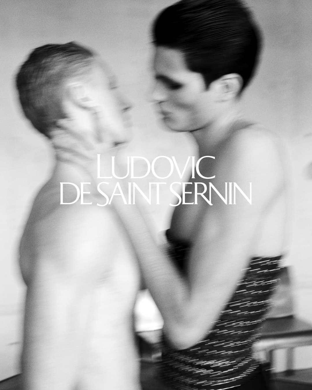Black and white portrait of two models facing each other with visible motion blur by Stuart Winecoff for Ludovic de Saint Sernin.