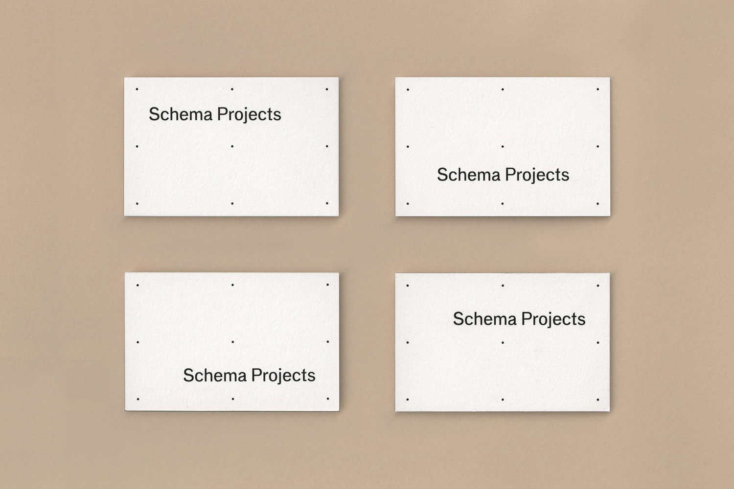 Four white rectangular cards with grid alignment dots and Schema Projects branding arranged on a beige background.