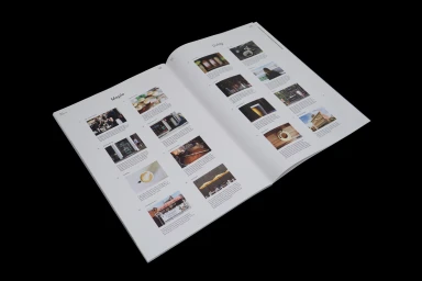 An open magazine spread featuring multiple photographic layouts and text sections against a dark background.