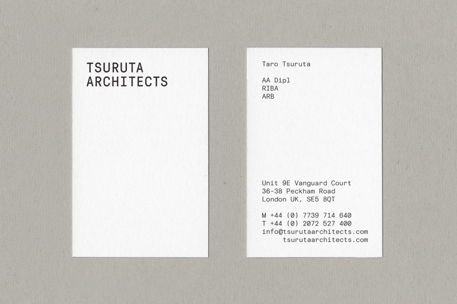 Front and back of a white business card for Tsuruta Architects featuring clean minimalist typography against grey textured paper.