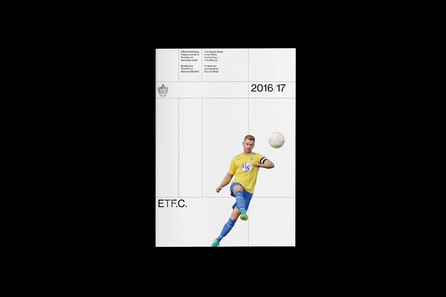 Graphic design matchday programme cover for Eastbourne Town FC featuring a male soccer player kicking a football against a white grid background
