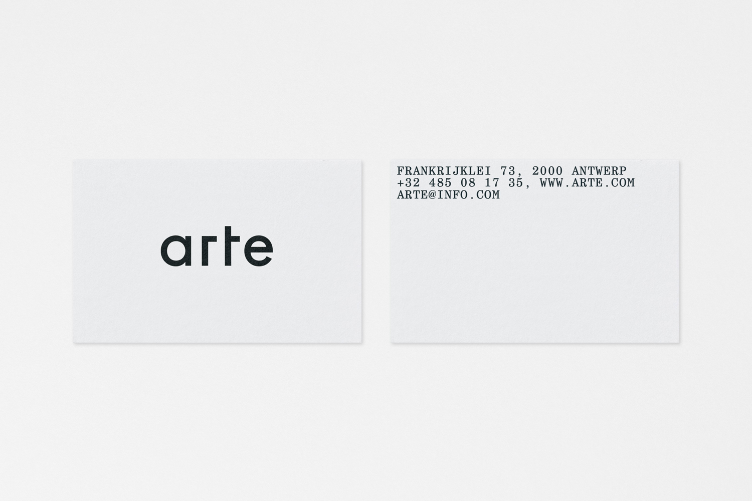 Two minimalist white business cards featuring lowercase black typography and contact info against a pale background