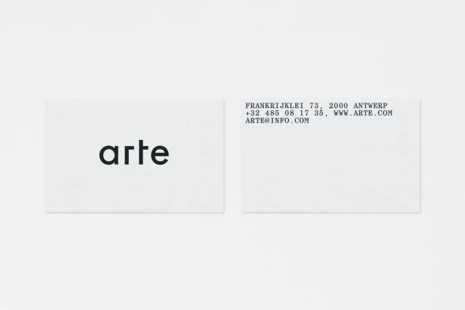 Two minimalist white business cards featuring lowercase black typography and contact info against a pale background