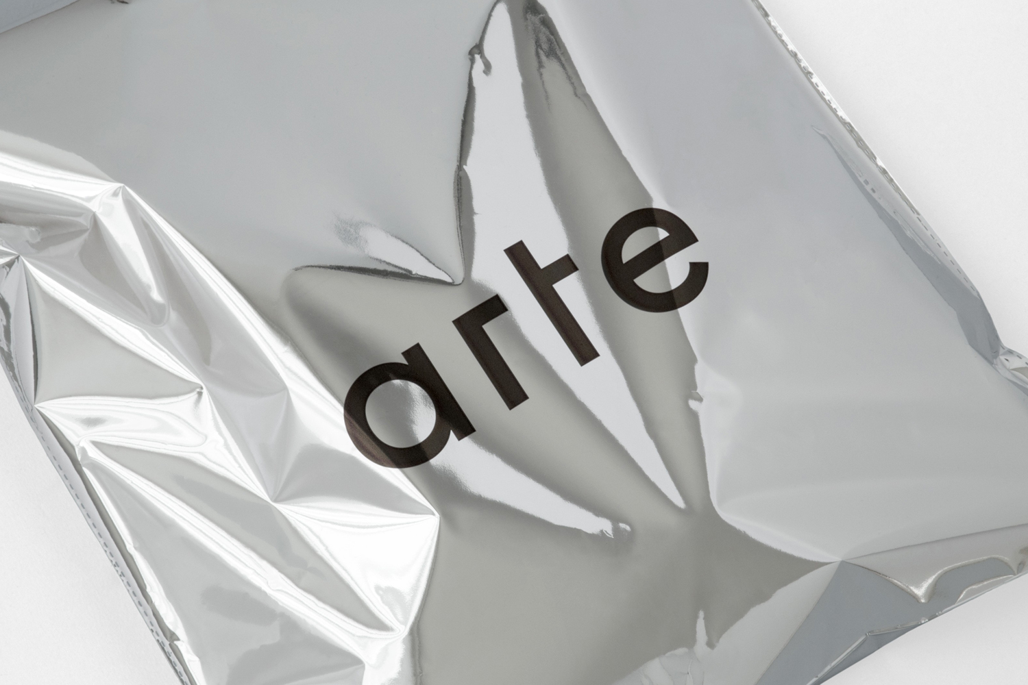 Metallic silver packaging bag featuring the Arte brand logo in black typeface against a white background