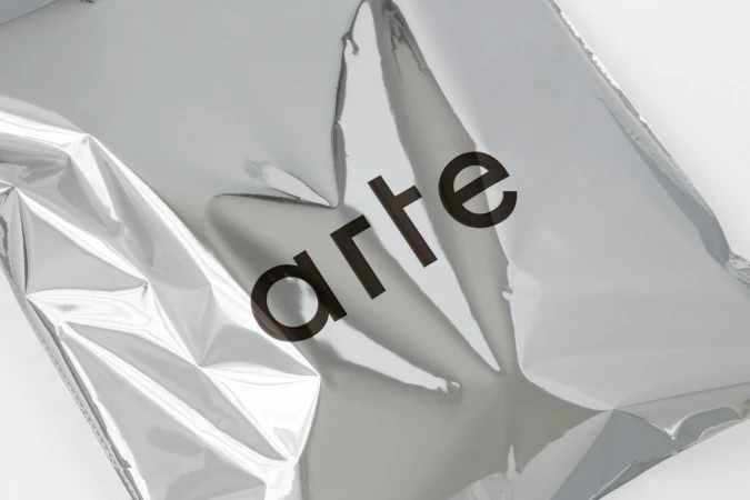 Metallic silver packaging bag featuring the Arte brand logo in black typeface against a white background