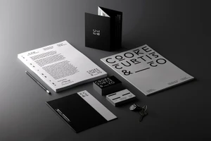 Cooke Curtis and Co brand identity stationery mockup featuring black and white letterhead, business cards, brochure, and keys on a grey surface.