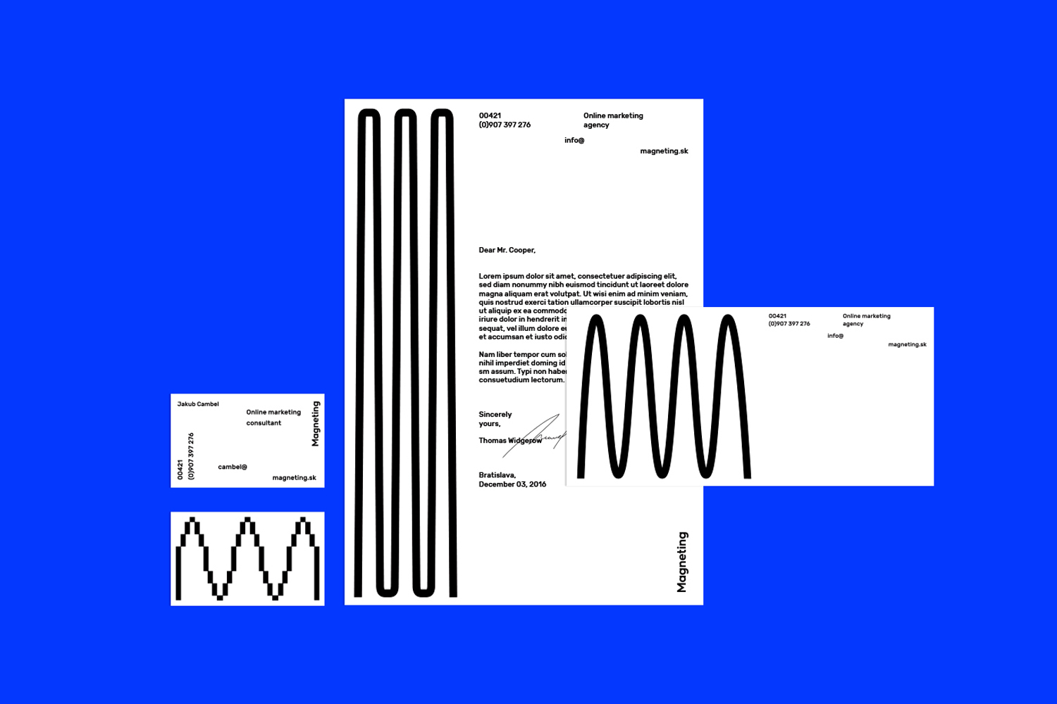 Magneting brand identity mockup featuring letterhead, business card, and graphic elements set against a vibrant blue background