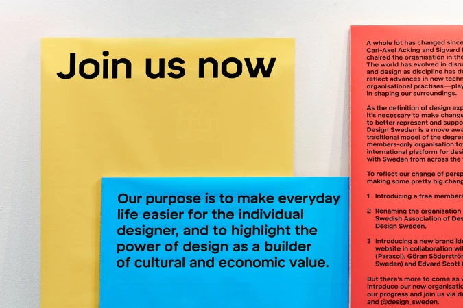 Close-up shot of yellow, blue, and red rectangular panels featuring bold black typography for Design Sweden's brand identity.