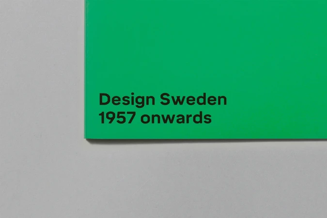 Close-up of a green book cover featuring black sans-serif typography resting on a grey surface.