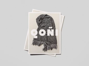 Stacked promotional prints featuring a dark grey knitted scarf with fringe and bold white Qoni typography on a grey background