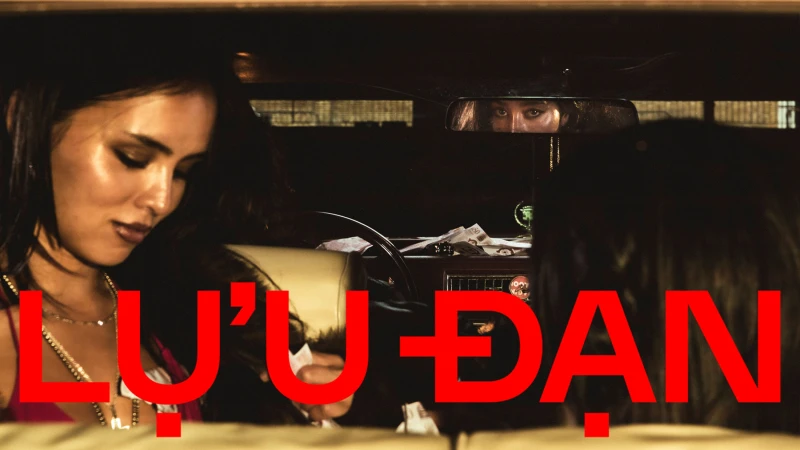 Two women seated inside a car at night with bold red Lu'u Dan brand text overlaid across the lower frame.