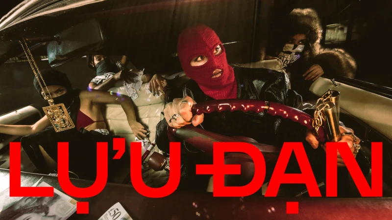 Models inside a car at night, featuring one in a red balaclava holding a steering wheel for Lu'u Dan